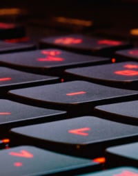 Illuminated red lights on a close-up keyboard.